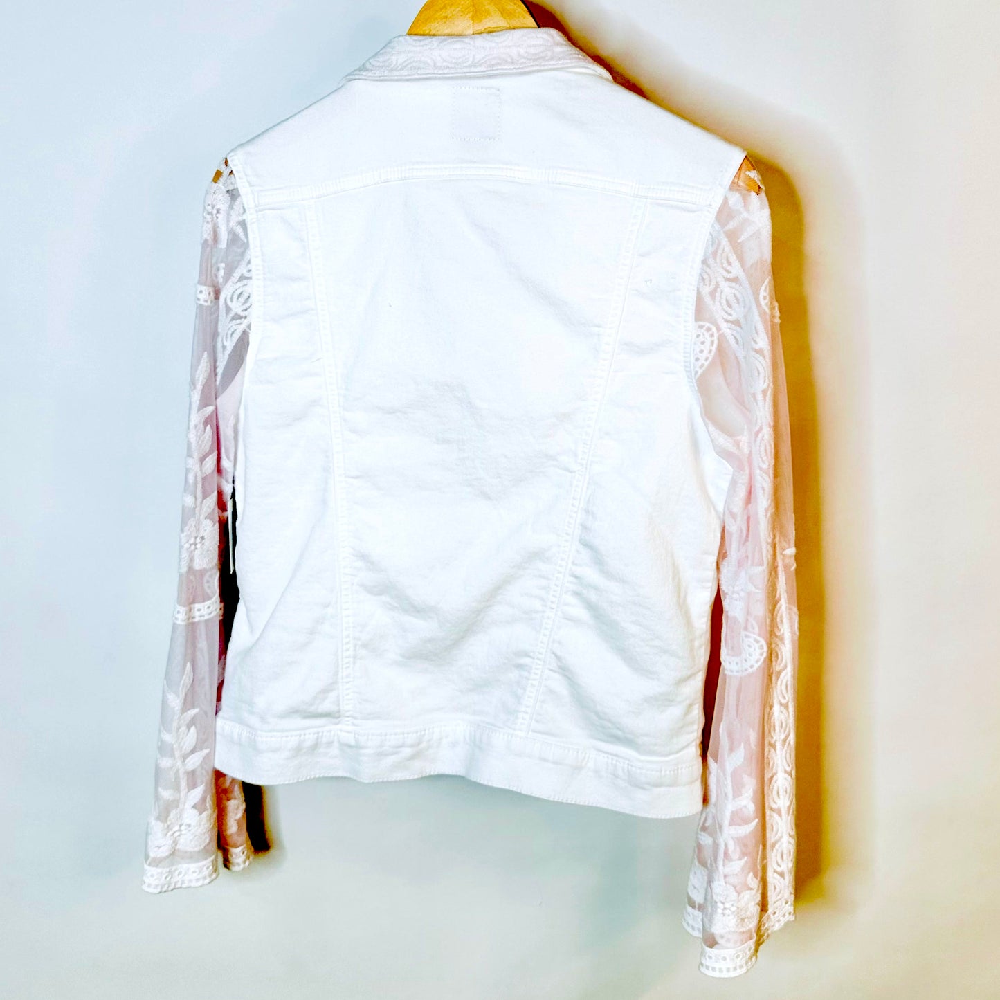 tinge of pink lace on a white jacket