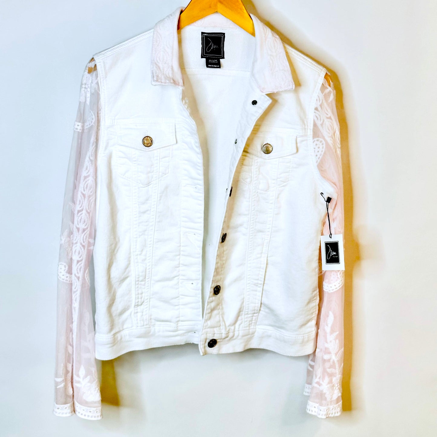 tinge of pink lace on a white jacket