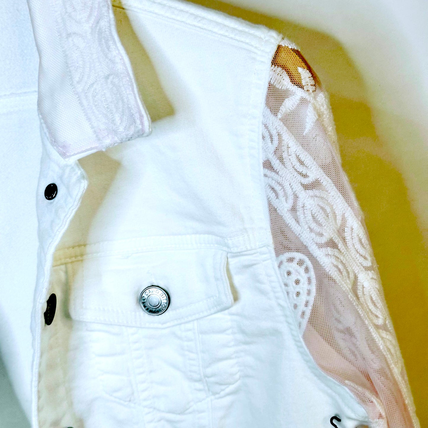 tinge of pink lace on a white jacket