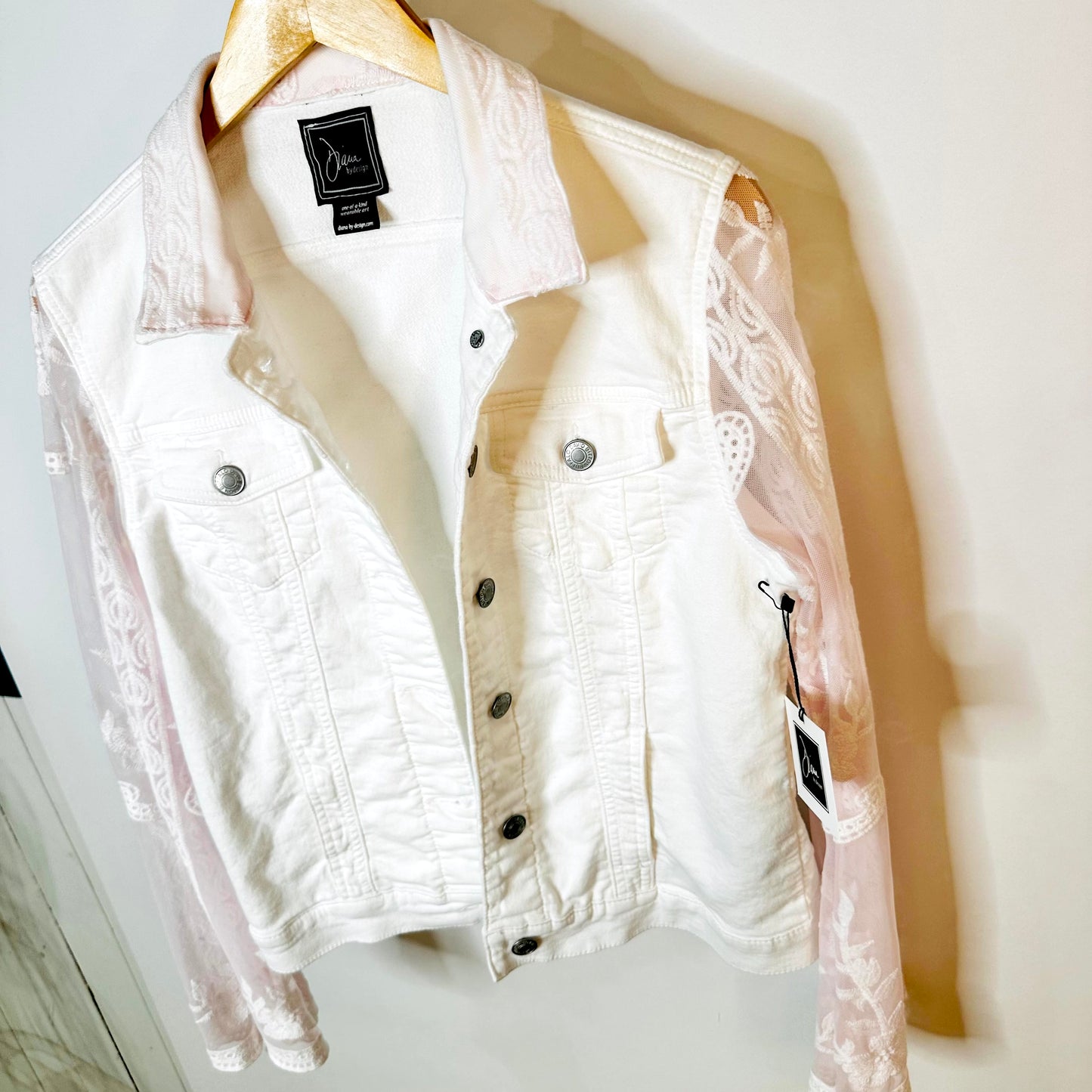 tinge of pink lace on a white jacket