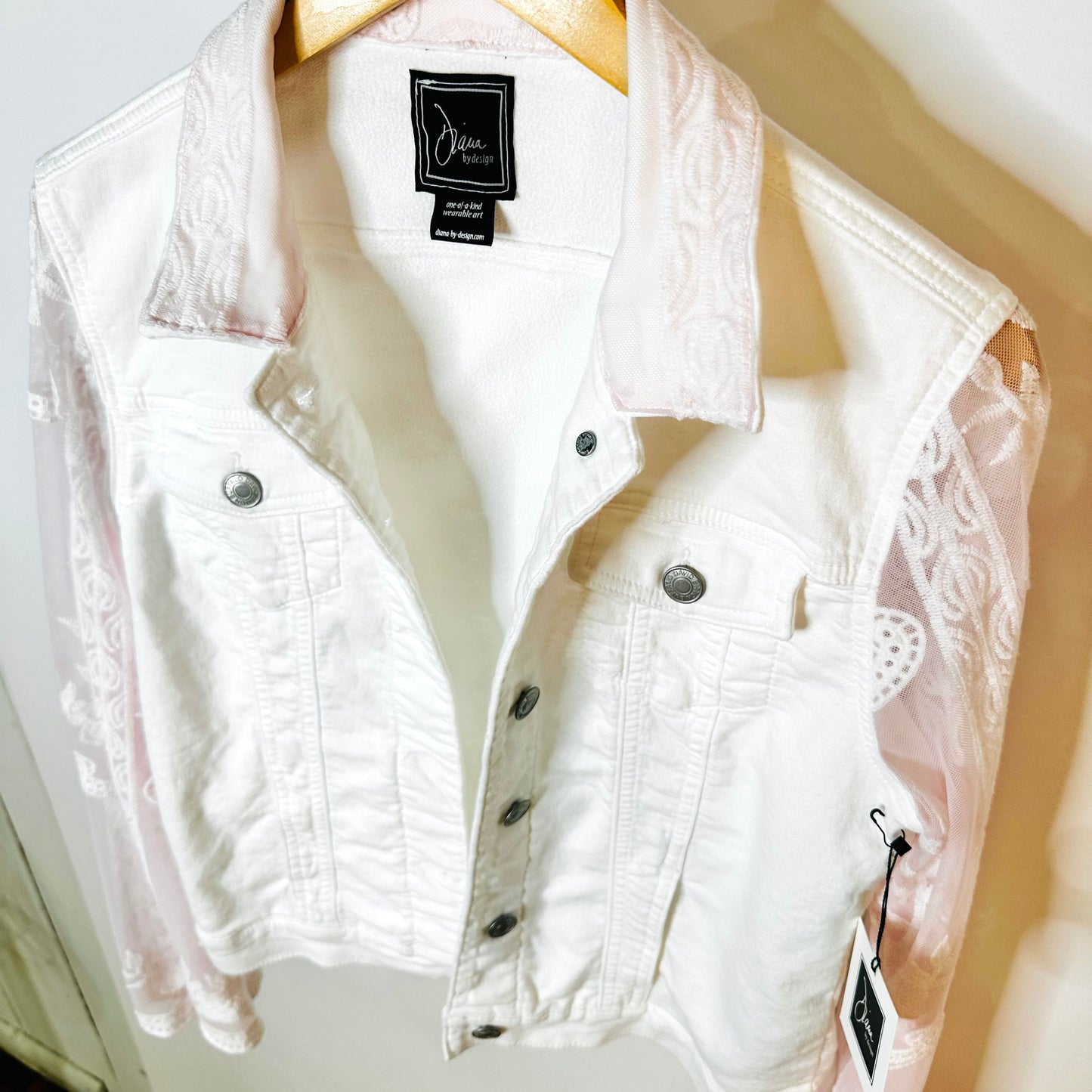 tinge of pink lace on a white jacket